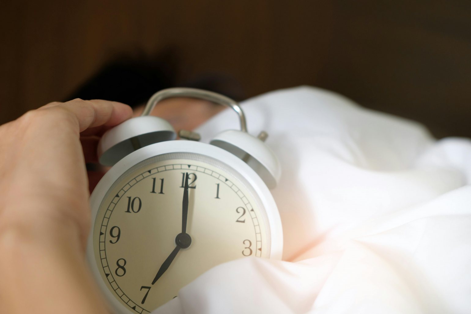 White Alarm Clock in white bedding